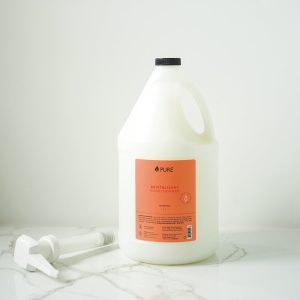 Pure brand organic and biodegradable conditioner in a white bottle with orange label.