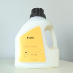 Pure brand organic and biodegradable fabric softener in a white bottle with orange label.