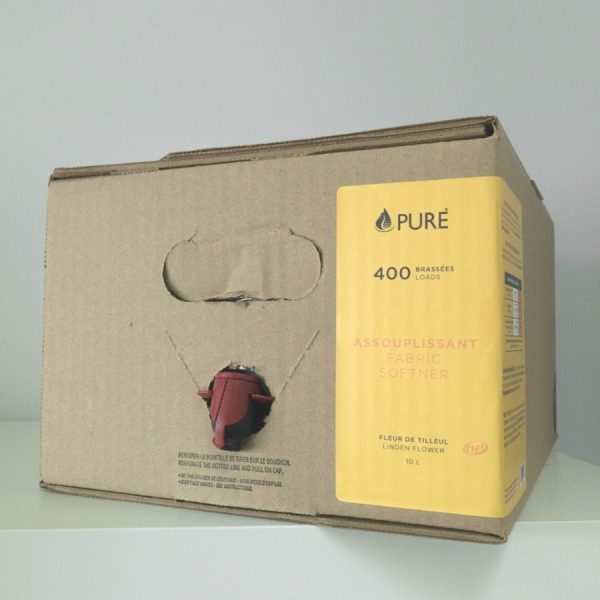 Pure brand organic and biodegradable fabric softener in bulk, stored in a box with a dispenser for refills.